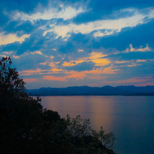 Scenic view of lake against sky during sunset