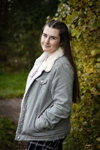 Portrait of a smiling young woman standing outdoors