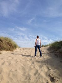 Full length of boy standing on sand at beach