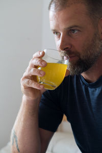 Man holding a glass with the dissolved vitamins