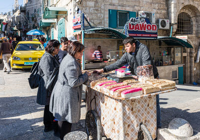 People standing on street in city