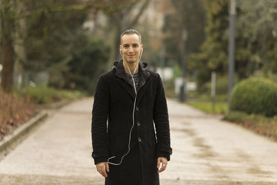 Portrait of smiling man standing outdoors