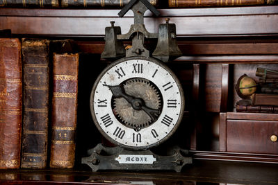 Close-up of clock on open book