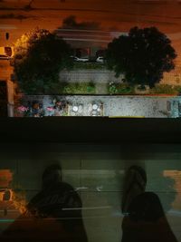 Silhouette people seen through glass window at night