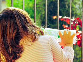 My daughter is a beautiful little girl photographed from the back while playing and is carefree