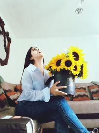 Woman holding yellow flowers