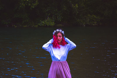 Young standing by lake