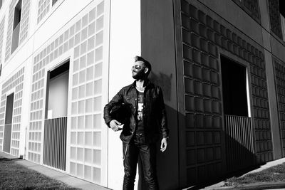 Low angle view of man standing against building