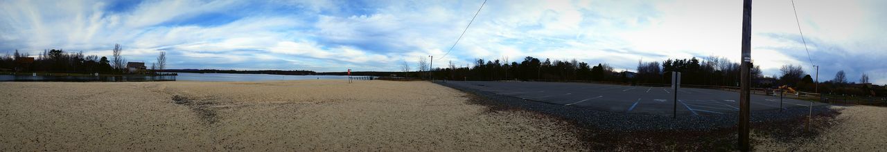 Empty road against cloudy sky