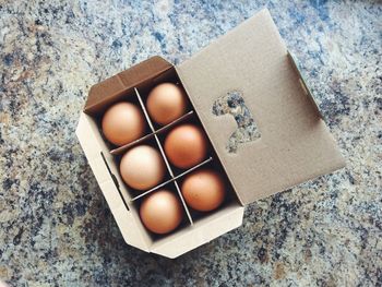 Directly above shot of eggs in box on marble floor