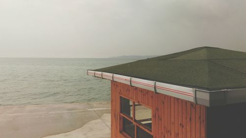 Scenic view of hut overlooking water