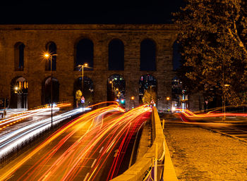 High angle view of light trails on road at night