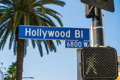 Low angle view of road sign against sky