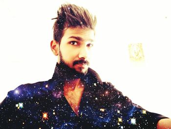 Portrait of young woman against white background