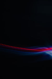 Light trails against black background