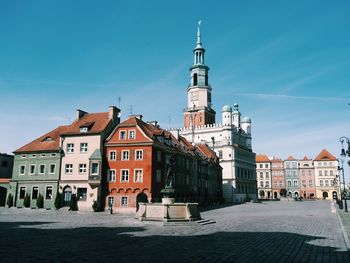 Buildings in town against blue sky