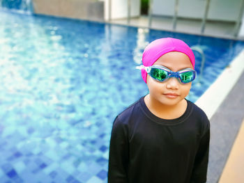 Portrait of boy standing in swimming pool