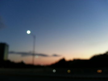 Close-up of illuminated lights against sky at night