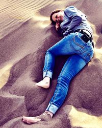 High angle view of woman lying on road