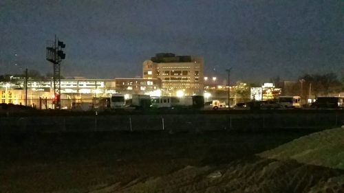 Illuminated buildings against sky at night