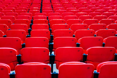 Full frame shot of empty red seats at stadium