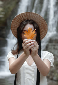 Midsection of woman holding camera