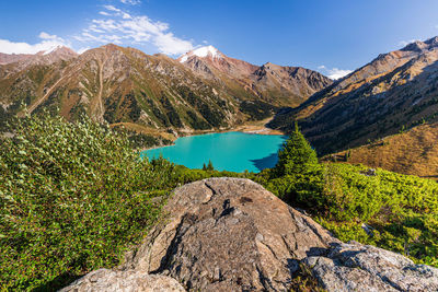 Scenic view of lake and mountains against sky