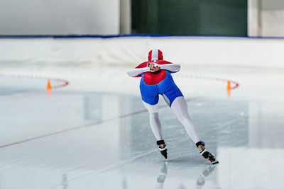 Back female skater run speed skating competition