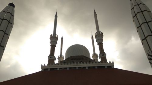 Low angle view of building against cloudy sky