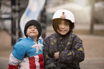 Portrait of smiling girl with brother at playground