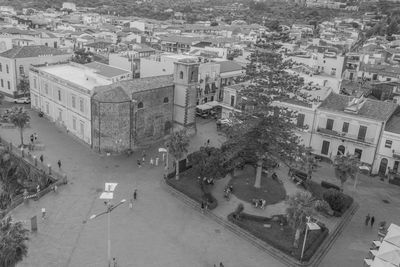 High angle view of people on street amidst buildings in city