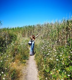 Man standing on field against clear sky