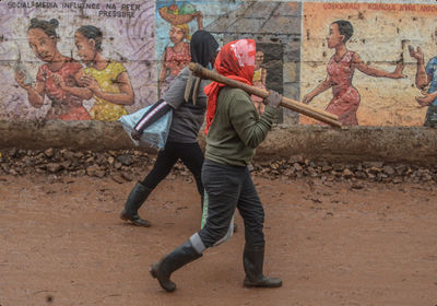 Rear view of man standing on footpath