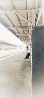 Woman sitting on wall