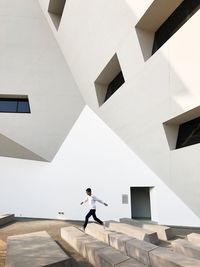 Low angle view of man walking on staircase