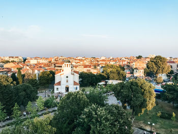 Buildings in town against clear sky