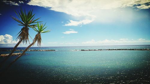 Scenic view of sea against cloudy sky