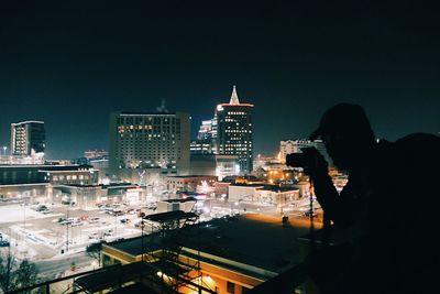 High angle view of illuminated cityscape against sky at night