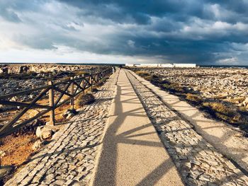 Empty road along countryside landscape