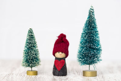 Close-up of christmas decorations on table against white background