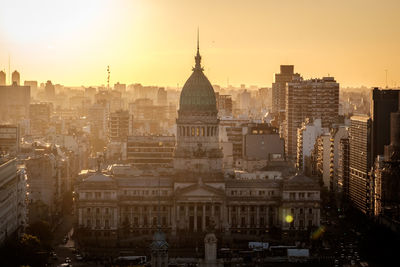 Cityscape against sky during sunset