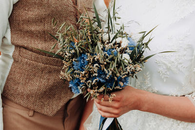 Close-up of hand holding flower bouquet