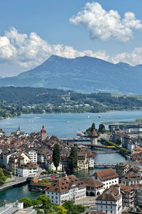 High angle view of townscape by mountains against sky