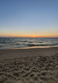 Scenic view of sea against clear sky during sunset