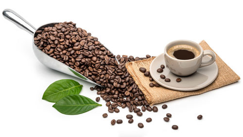 High angle view of coffee beans against white background