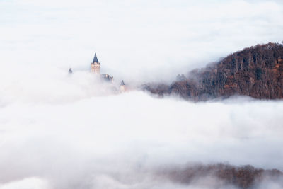 View of church on mountain amidst cloud