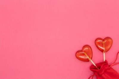 Close-up of heart shape over pink background