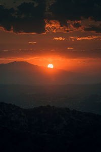 Scenic view of silhouette mountains against sky during sunset