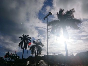 Low angle view of silhouette palm trees against sky at sunset