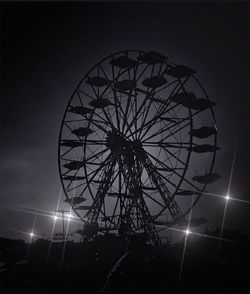 Low angle view of ferris wheel at night